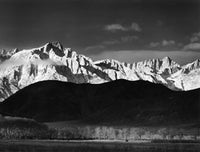 a black and white photo of a snow covered mountain 